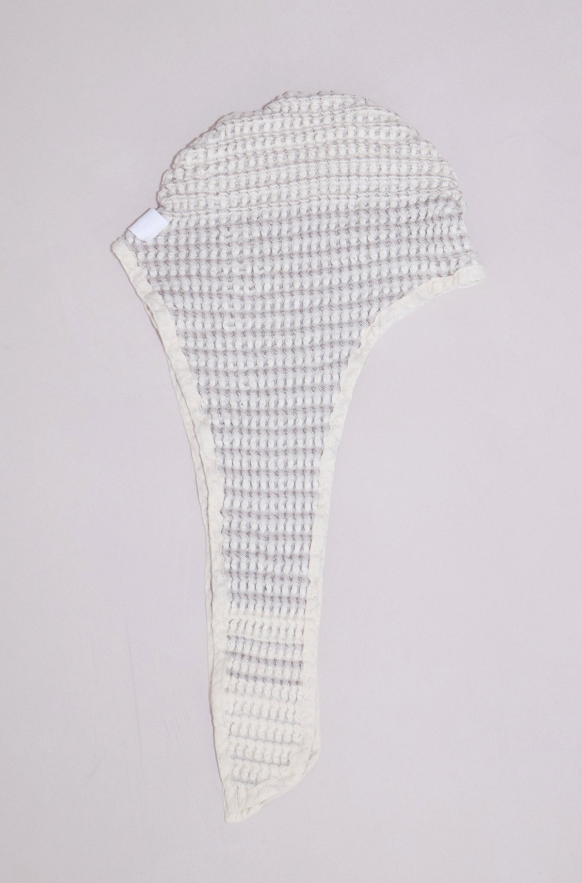 Close-up of sand baby bath bonnet showing soft natural cotton texture