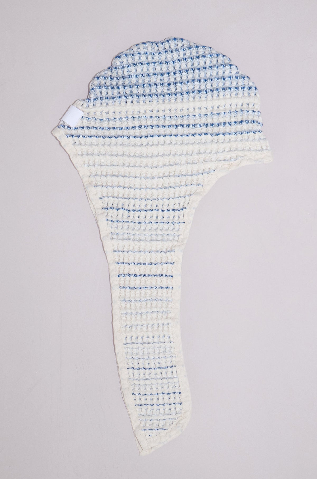 Close-up of Tide baby bath bonnet showing soft natural cotton texture