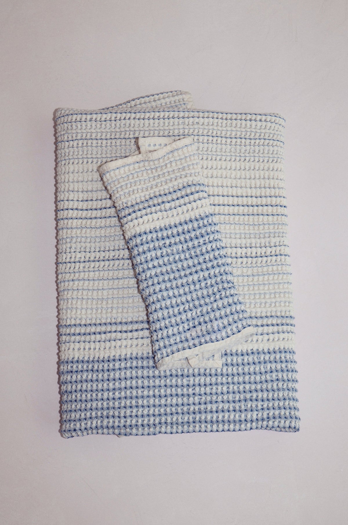 Tide-colored cotton receiving baby towel set folded on a light surface