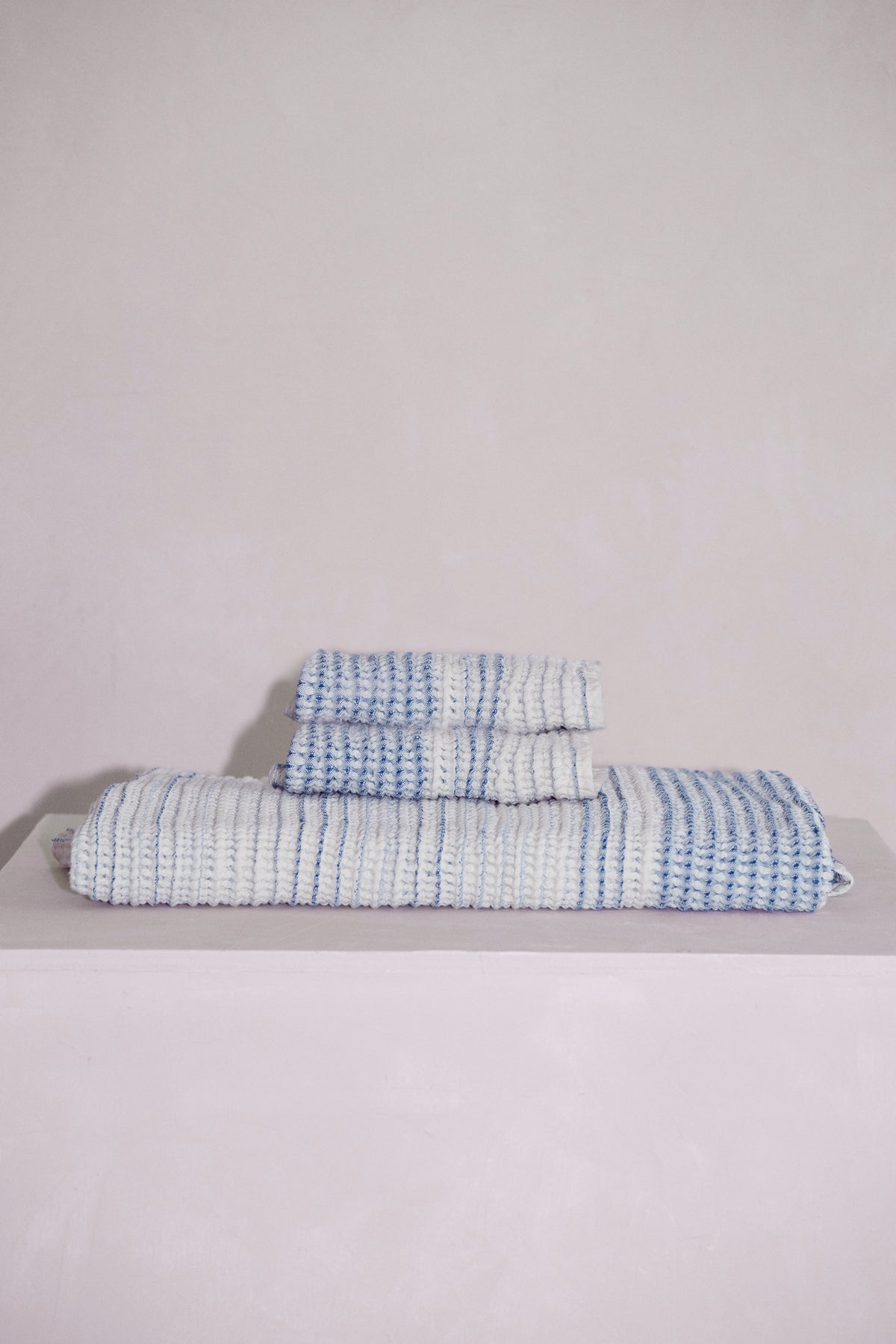 Stacked Tide baby receiving towels highlighting soft natural fibers