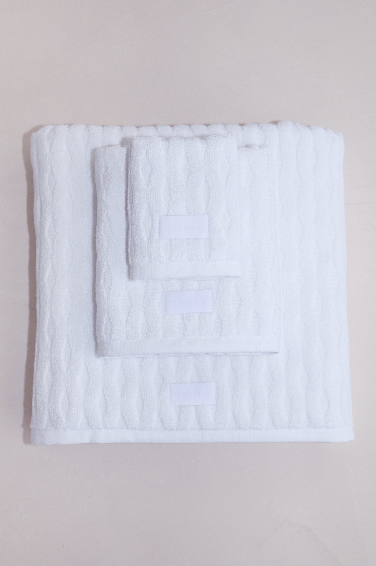 Cotton-linen Ellipse towel set folded flat, showing soft terrycloth texture and color